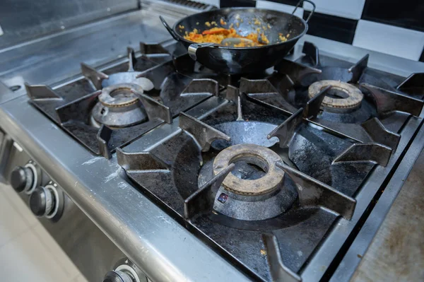 Stove off in a kitchen with a pan of rice