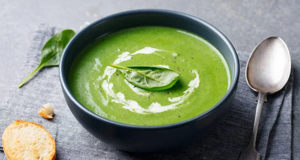 Spinach soup with cream in a bowl. Close up. — Stock Image Spinach soup with cream in a bowl. Close up. Stock Photo