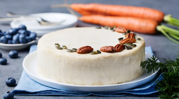 Vegan, raw carrot cake. Healthy food. Grey stone background. Close up.