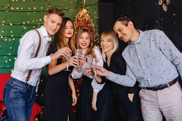 big company celebrates a new year with glasses of champagne at home