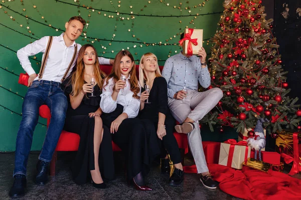 big company celebrates a new year with glasses of champagne at home