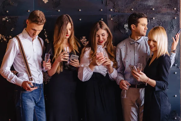 big company celebrates a new year with glasses of champagne with phones mania at home