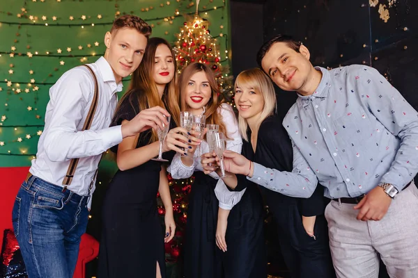 big company celebrates a new year with glasses of champagne at home