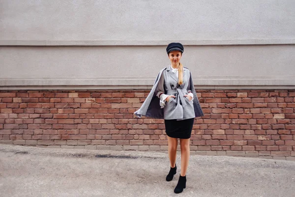 Uma garota bonita e fofa em um terno elegante anda pela cidade e posa — Fotografia de Stock