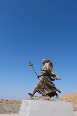 Gaochang harabelerinde Tang Rahibi Tang Sanzang 'ın metal heykeli, T