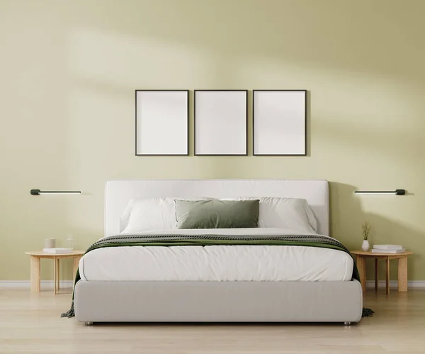 Three blank frames mock up above bed in bedroom interior in light green tone, 3d render