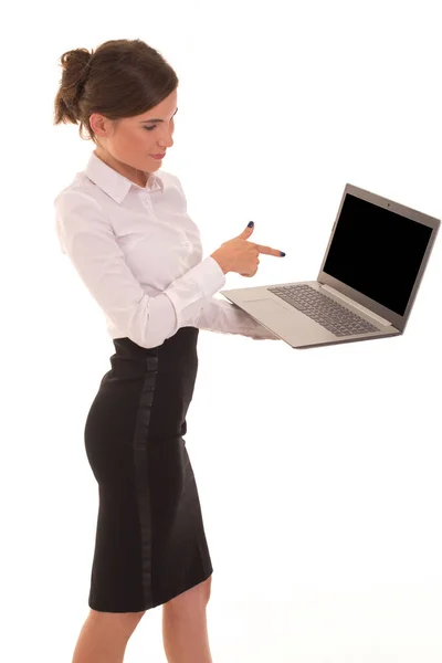 Office worker holds a laptop and points at it. — Stock Photo, Image