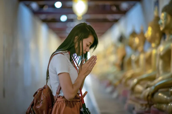 Woman pray respect to the buddha statue in the temple, Thai and Asia traditional and culture in religion spiritual