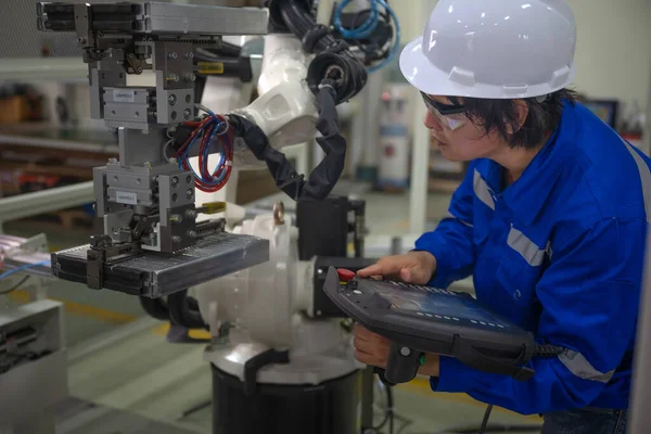 supervisor inspect or testing the system of robotic brand new in smart factory modern, working robotic machinery working together with human control in modern factory