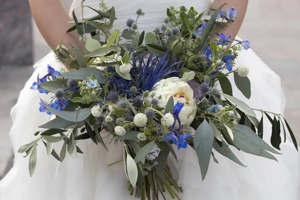 Wedding bouquet of dried flowers, eucalyptus, peony, dahlias and dolphinium
