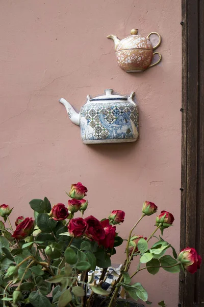 Pół ceramiczne czajniki przyklejone na ścianie domu w Wilnie — Zdjęcie stockowe