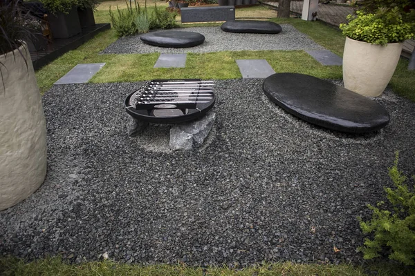 the Japanese-style garden with large boulders with barbecue grill