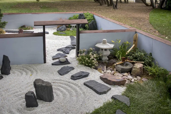 The Japanese garden with ikebana, sand and rake — Stock Photo, Image