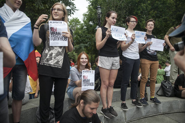 Young people are holding posters in protest against police brutality.