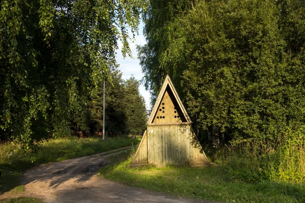 Rustic toilet in the form of a triangular house in an old village in summer time. — Stock Image Rustic Toilet Form Triangular House Old Village Summer Time Stock Image