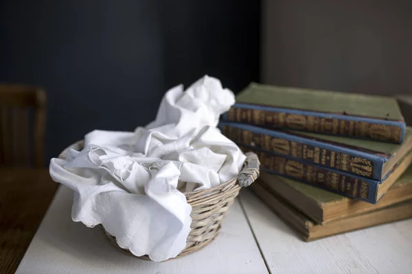 Wicker Basket White Cutwork Cloth Table Stack Old Books Copy — Stock Photo, Image