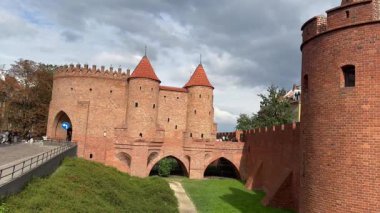 Warsaw, Poland, 5 May 2025, fragments of the city wall and Barbican, a semicircular fort with towers that defended the wall from the northeast at the Florian Gate.