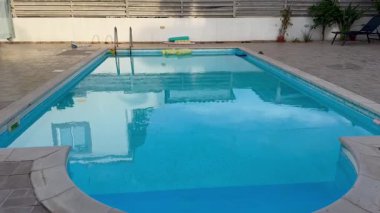 Swimming pool with water in the courtyard of a villa, without people, round-shaped