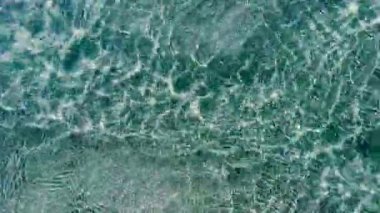 Wave in the sea in sunlight, reflections and distortion. Sea in blue tones