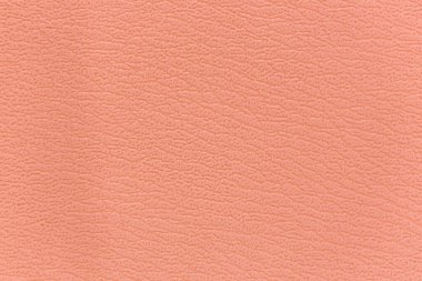 Kanepenin yüzeyinde yapay deri bir arka plan var.