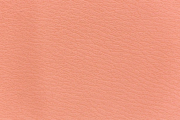 Kanepenin yüzeyinde yapay deri bir arka plan var.