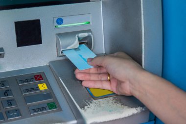 Banka makinesine para çekmek için ATM kartı yerleştiriliyor.