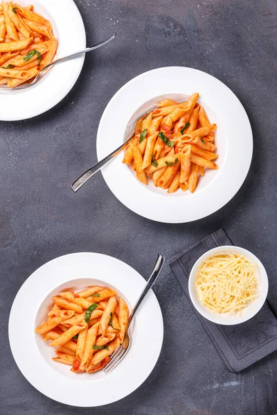 Three Plates Penne Alla Vodka Dark Background Vertical — Stock Photo, Image