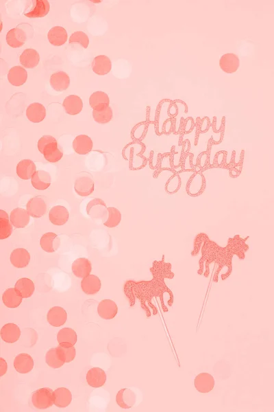 Creative pastel fantasy holiday card with cupcake, happy birthday lettering and unicorn. Baby shower, birthday, celebration concept. Vertical. Living coral theme - color of the year 2019