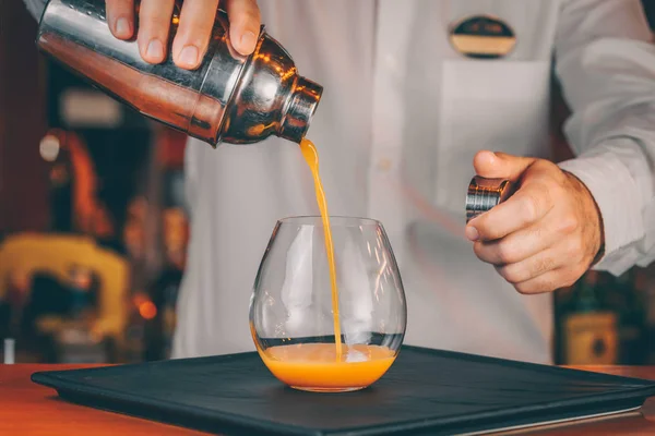 Barman pouring  cocktail at a nightclub. Nightlife and entertainment concept. Horizontal