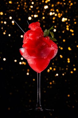 Frozen strawberry margarita on the dark background with festive holiday bokeh.  Luxury craft drink concept clipart