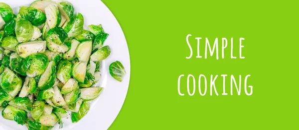 Lightly fried brussels sprouts on a white plate on the solid color drop — Stock Photo, Image