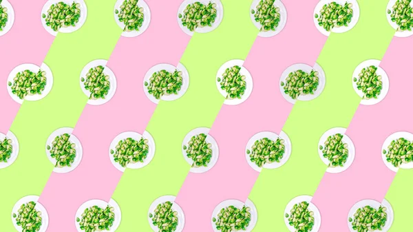 Pattern of plates with lightly fried brussels sprouts on the neon green and pink color drop — Stok fotoğraf