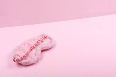 Cute flaffy sleeping mask on duotone pink drop