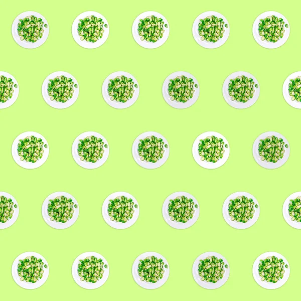 Pattern of plates with lightly fried brussels sprouts on the neon green drop — Stok fotoğraf