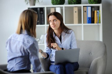 Takım çalışması. Açık uzay ofisinde dizüstü bilgisayarı olan iki kadın. İş konsepti.