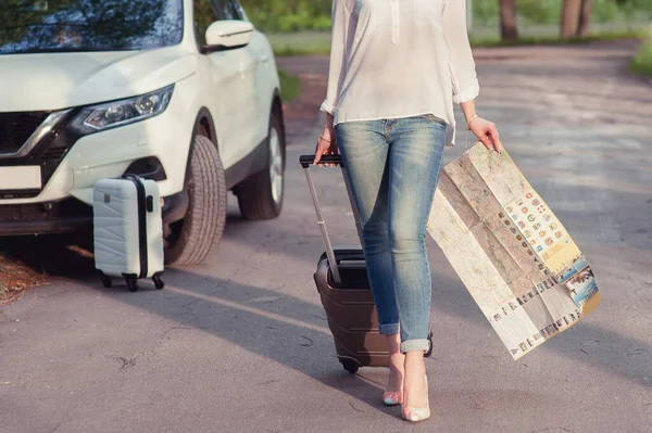 A blonde woman near with luggage