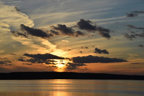 evening sunset on  river sea bright light reflection water clouds sk