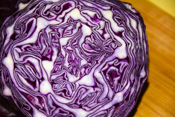 cooking red fresh raw cabbage ornament on a wooden board blue knif