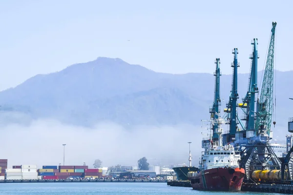 industrial port blue water clear weather white fog on the backgr