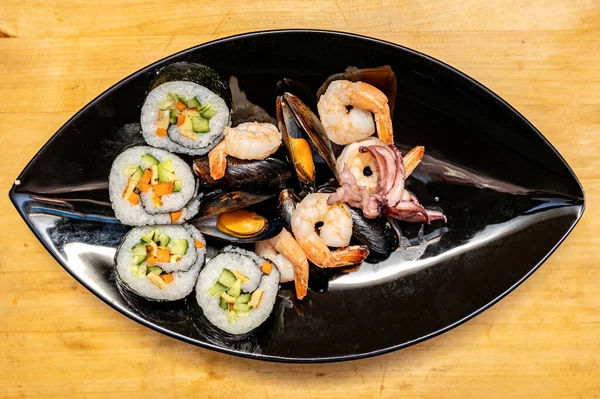 Sushi Rolls Shrimps Mussels Black Plate Wooden Table Top View — 스톡 사진