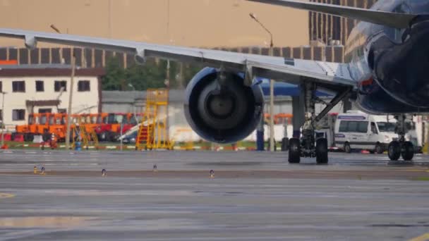 Edificios y equipos del aeropuerto a través de la bruma de calor del motor a reacción Boeing 777 — Vídeo de stock