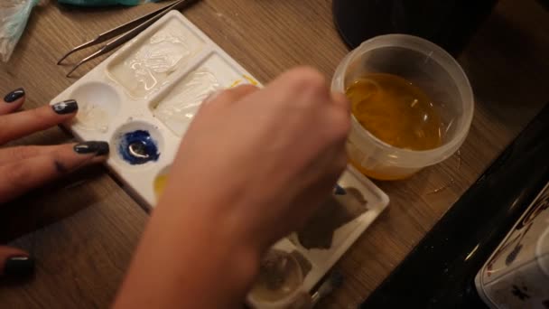 女人混合了可食用的油漆. 白色调色板中的甜食色 — 图库视频影像