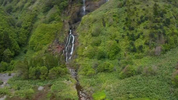 Wasserfall fällt von der Spitze des hohen Berges mit Wolken bedeckt. Antenne des grünen Steilhangs — Stockvideo