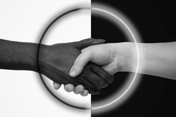 Black hand on a white background, white on black, joined in a handshake and United by a circle icon. The concept of interracial friendship and respect, the fight against racism