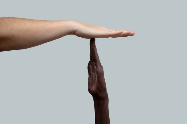 타임아웃 아이콘을 보여준다 손바닥에 닿는다 인종간의 우정과 존중이라는 차별과의 — 스톡 사진