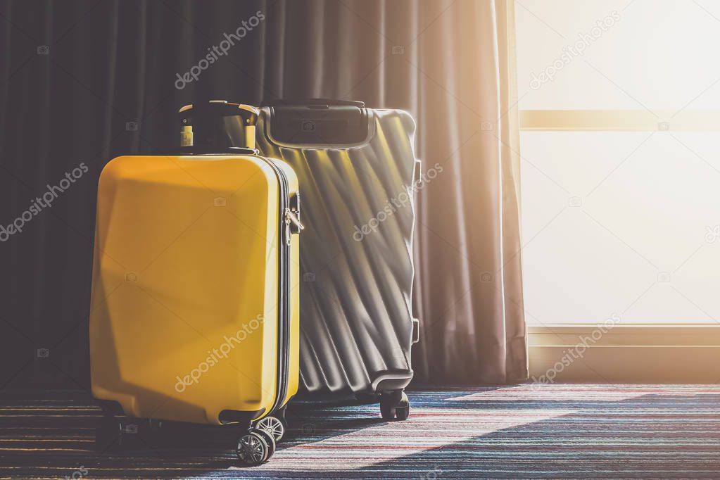 Suitcase Luggage bag in the bedroom with open curtain see sunrise light
