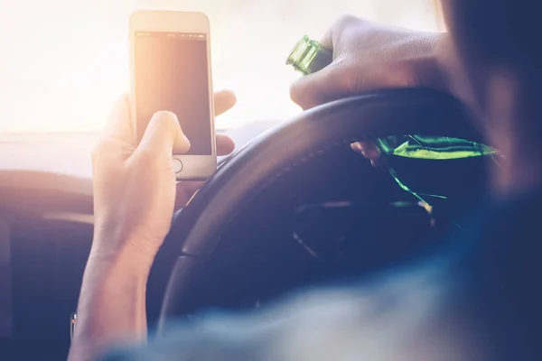 Drinking and driving ,man drinking alcohol and using mobile phone while driving car ,concept drive safely while using a cell phone or drunk alcohol — Stock Photo, Image