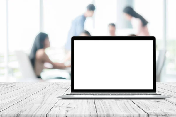 Laptop blank mock up screen placed on white wooden table on blurred people meeting in coffee shop cafe co-working space — Stock Photo, Image