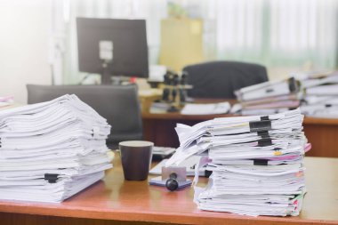 Heap of paperwork stack documents on office desk ,business documents billing and examination to report the summary results annual report for presented. Business offices concept clipart