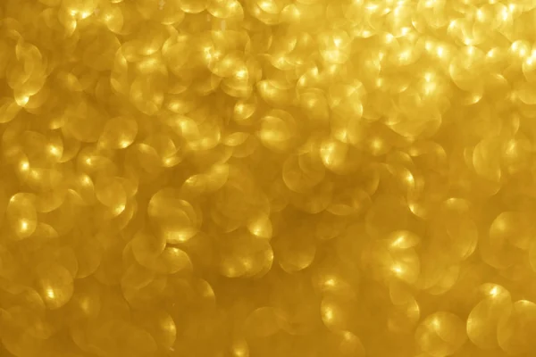 Abstract gold sparkles shiny defocused gold bokeh lights background use us gold luxury background for card, flyer, invitation, placard, voucher or banner background